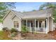 Charming home with a cozy front porch, complete with hanging flower baskets and a well-manicured garden at 50 Rainwood Ct, Louisburg, NC 27549