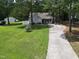 Charming single-Gathering home with a well-manicured lawn, long driveway and mature trees at 50 Rainwood Ct, Louisburg, NC 27549