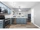 Spacious open concept kitchen with stainless steel appliances, bright countertops and views of the living area at 50 Rainwood Ct, Louisburg, NC 27549