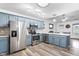 Modern kitchen featuring stainless steel appliances, custom blue cabinetry, and stylish backsplash at 50 Rainwood Ct, Louisburg, NC 27549