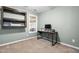 Bright office with carpet, natural light from the window, a wood and metal desk, and a shelf at 50 Rainwood Ct, Louisburg, NC 27549