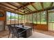 Covered screened patio with metal roof, gravel, and a table and chairs for outdoor seating at 50 Rainwood Ct, Louisburg, NC 27549