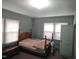 Bedroom featuring wood bed frame, mint walls and light fixtures providing a simple cozy space at 500 W Main St, Benson, NC 27504