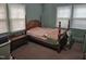 Bedroom with a four-poster bed and matching furnishings at 500 W Main St, Benson, NC 27504