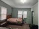 Bedroom featuring wood bed frame, mint walls and light fixtures providing a simple cozy space at 500 W Main St, Benson, NC 27504