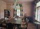 Dining room showcasing a chandelier, a dining table set, and floral-patterned curtains at 500 W Main St, Benson, NC 27504