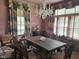 Elegant dining room featuring a chandelier, large table, decorative curtains, and plenty of natural light at 500 W Main St, Benson, NC 27504