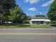 Beautiful two-story home with a large front yard and inviting covered front porch with mature landscaping at 500 W Main St, Benson, NC 27504