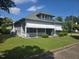 Charming two-story home boasts a covered porch and well-maintained lawn in a quiet neighborhood at 500 W Main St, Benson, NC 27504