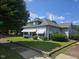 Traditional two-story home with a cozy covered front porch and mature trees in the front yard at 500 W Main St, Benson, NC 27504