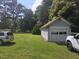 Detached garage with roll-up door located on a well-maintained lawn, offering ample parking at 500 W Main St, Benson, NC 27504