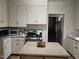 Traditional kitchen design with an island, white cabinets, stainless appliances and plenty of storage at 500 W Main St, Benson, NC 27504