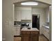 Functional kitchen with an island, white cabinets, and stainless steel appliances at 500 W Main St, Benson, NC 27504