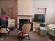 A vintage living room with old furniture, a fireplace, and neutral color scheme at 500 W Main St, Benson, NC 27504