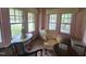 Sun room showcasing period furnishings and large windows for ample light at 500 W Main St, Benson, NC 27504