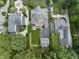 An aerial view of an elegant home with a manicured lawn, mature trees, and luxurious landscaping at 504 Yarmouth Rd, Raleigh, NC 27608