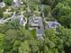 Stunning aerial view of a luxury home with lush landscaping, manicured lawn, and mature trees at 504 Yarmouth Rd, Raleigh, NC 27608