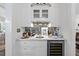 The beverage bar features custom cabinets, marble countertops, a mirrored backsplash, and a wine cooler at 504 Yarmouth Rd, Raleigh, NC 27608