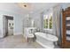 Elegant bathroom boasts a soaking tub, glass-enclosed marble shower, and natural light at 504 Yarmouth Rd, Raleigh, NC 27608