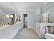 Bright bathroom featuring marble countertops, dual sinks, a glass-enclosed shower, and elegant fixtures at 504 Yarmouth Rd, Raleigh, NC 27608