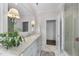 Bright bathroom with a marble countertop vanity, white cabinets, and a glass-enclosed shower at 504 Yarmouth Rd, Raleigh, NC 27608