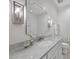Elegant bathroom with a marble countertop, decorative mirror, and sophisticated sconces offer a relaxing retreat at 504 Yarmouth Rd, Raleigh, NC 27608