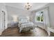 Bright bedroom with a beautiful window view and hardwood floors, featuring a comfortable bed and bench at 504 Yarmouth Rd, Raleigh, NC 27608