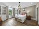 Cozy bedroom with large windows, hardwood floors, and built-in shelves provides a serene and inviting space at 504 Yarmouth Rd, Raleigh, NC 27608