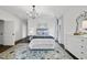 Bright bedroom with blue accents, featuring a chandelier and decorative area rug on hardwood floors at 504 Yarmouth Rd, Raleigh, NC 27608