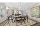 Formal dining room with a large wooden table, chandelier, and elegant decor at 504 Yarmouth Rd, Raleigh, NC 27608