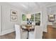 Breakfast nook with hardwood floors, round table, and views of the outside through large windows at 504 Yarmouth Rd, Raleigh, NC 27608