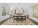 Formal dining room with chandelier, large windows, and seating for eight is great for entertaining at 504 Yarmouth Rd, Raleigh, NC 27608