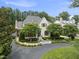 Stunning exterior of a white painted brick home with manicured landscaping and an asphalt driveway at 504 Yarmouth Rd, Raleigh, NC 27608