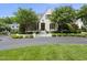 Charming two-story home with landscaped yard, circular drive, and blooming trees at 504 Yarmouth Rd, Raleigh, NC 27608