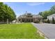 Stunning home with a large lawn, covered porch, and a long driveway leading to the house at 504 Yarmouth Rd, Raleigh, NC 27608
