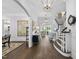 Elegant foyer with hardwood floors, white trim, staircase, and decorative lighting fixtures at 504 Yarmouth Rd, Raleigh, NC 27608