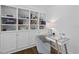 A well-organized home office features custom built-ins and a glass desk creating a focused work environment at 504 Yarmouth Rd, Raleigh, NC 27608