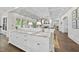 Open kitchen with marble countertops, modern fixtures, and an open layout into the living room at 504 Yarmouth Rd, Raleigh, NC 27608