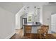Charming kitchen featuring white cabinets, breakfast bar with wooden chairs, and stainless steel appliances at 504 Yarmouth Rd, Raleigh, NC 27608