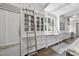 Bright, well-organized kitchen with white cabinetry, marble countertops, and a library ladder for easy access at 504 Yarmouth Rd, Raleigh, NC 27608