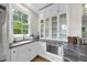 Bright kitchen with white cabinetry, marble countertops, stainless steel appliances, and a large window at 504 Yarmouth Rd, Raleigh, NC 27608