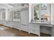 Custom white cabinets, marble countertops, and hardwood floors make for an elegant, functional kitchen space at 504 Yarmouth Rd, Raleigh, NC 27608