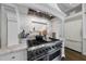 Gourmet kitchen featuring a stainless steel range hood, marble backsplash, and professional-grade appliances at 504 Yarmouth Rd, Raleigh, NC 27608