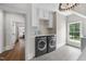 Laundry room features large front load washer and dryer, utility sink and storage at 504 Yarmouth Rd, Raleigh, NC 27608