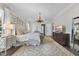 Spacious main bedroom showcases a decorative chandelier, plush rug, and calming neutral color palette at 504 Yarmouth Rd, Raleigh, NC 27608