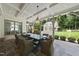 Covered outdoor dining area with large table, seating and view of the backyard at 504 Yarmouth Rd, Raleigh, NC 27608