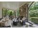 Cozy outdoor living space with a stone fireplace and comfortable seating at 504 Yarmouth Rd, Raleigh, NC 27608