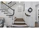 Elegant staircase with dark wood steps and white railings, accented by architectural wall art at 504 Yarmouth Rd, Raleigh, NC 27608