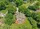 Aerial view of home featuring a large backyard, mature landscaping and circular driveway at 5108 Briton Pl, Fuquay Varina, NC 27526