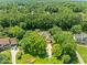 Aerial view of home nestled amongst mature trees in a well established neighborhood at 5108 Briton Pl, Fuquay Varina, NC 27526